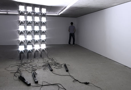 Santiago Sierra, Audience Lit by a Petrol Operated Generator, 2008; Veteran of Iraq War Facing the Wall, 2011